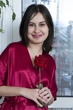 Eva Black poses with her red rose nearby
